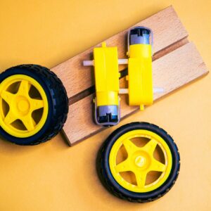 Close-up of yellow robotic wheels and motors, ideal for engineering projects.