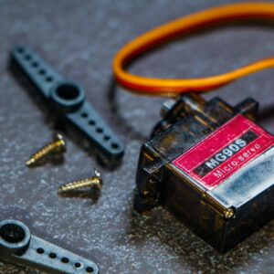 Detailed view of an MG90S micro servo motor with screws and components for robotics applications.